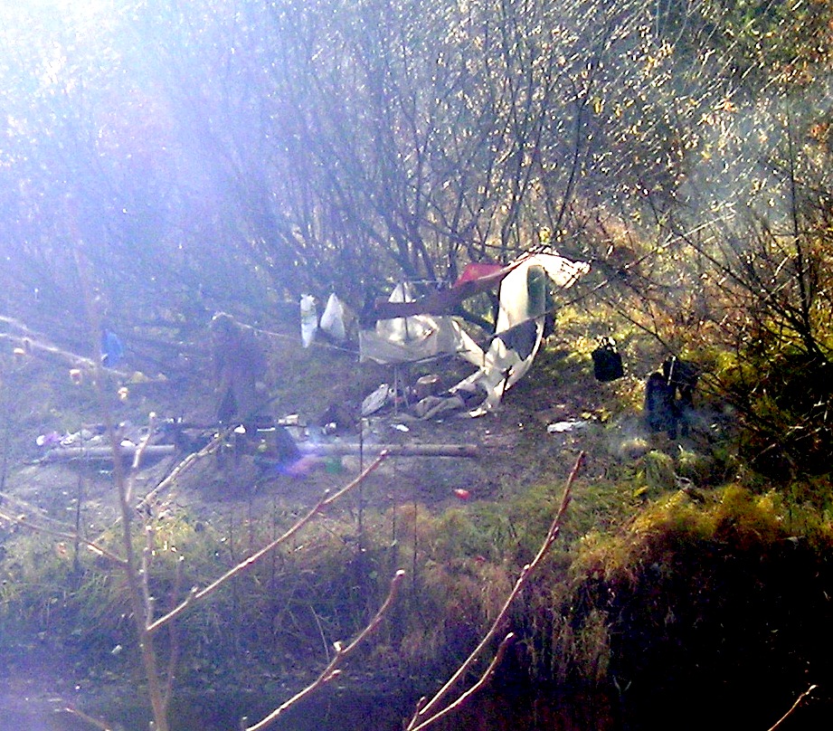 A bivouac on the Linda River. A former sailor lives and sleeps by a campfire under a bush, keeping his belongings in the trees. October 2009
