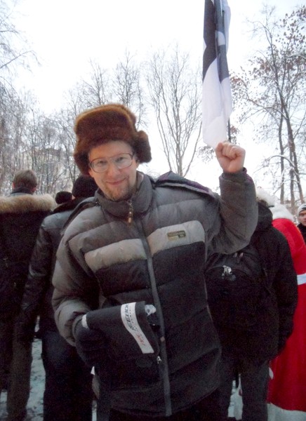 Democratic rally of 24 December 2011 on Freedom Square . Professor Rastolkovsky hands out books about his inventions