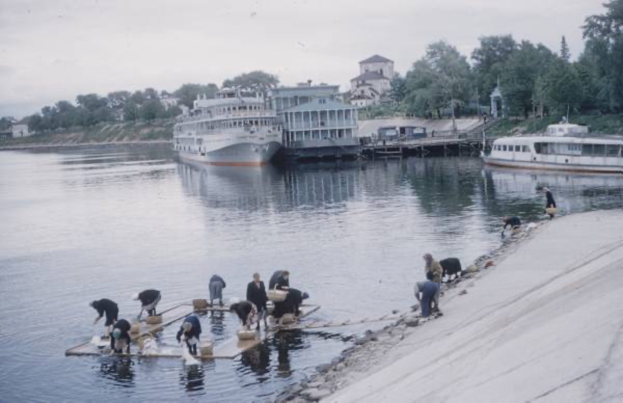 Washing laundry on rafts by the river landing