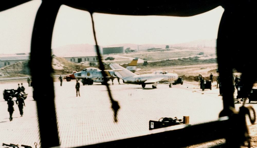 No Kum-sok's MiG-15bis at Kimpo Air Base, South Korea, minutes after he landed on 21 September 1953; an American F-86 Sabre stands behind it